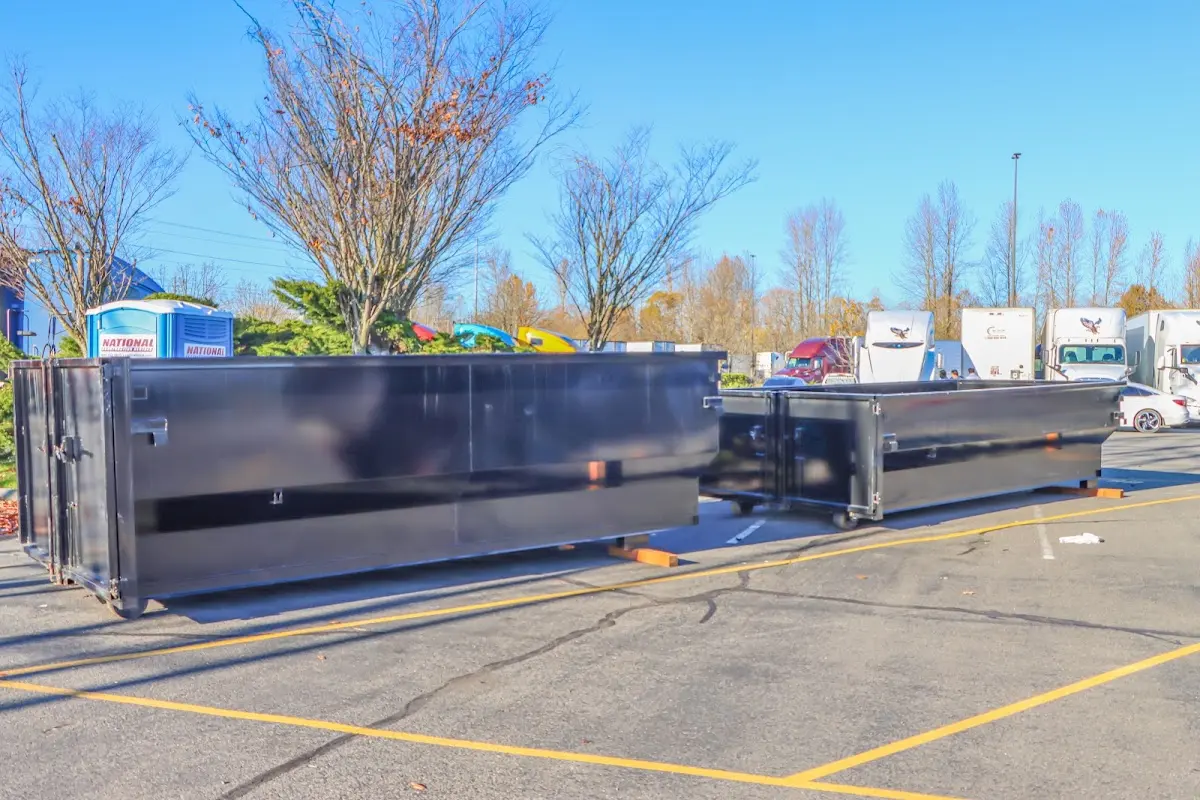 Professional dumpster rental service with roll-off container on residential driveway in Boyes Hot Springs